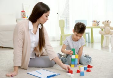 Young child psychologist working with little boy