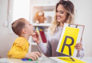 Speech therapist teaches the boys to say the letter R